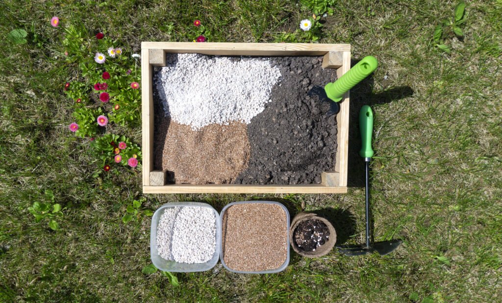 Preparation of the soil mixture from natural fertilizers, soil additives and improvers for transplanting seedlings and growing vegetables. Biohumus, compost, vermiculite, perlite in bowls on a lawn.